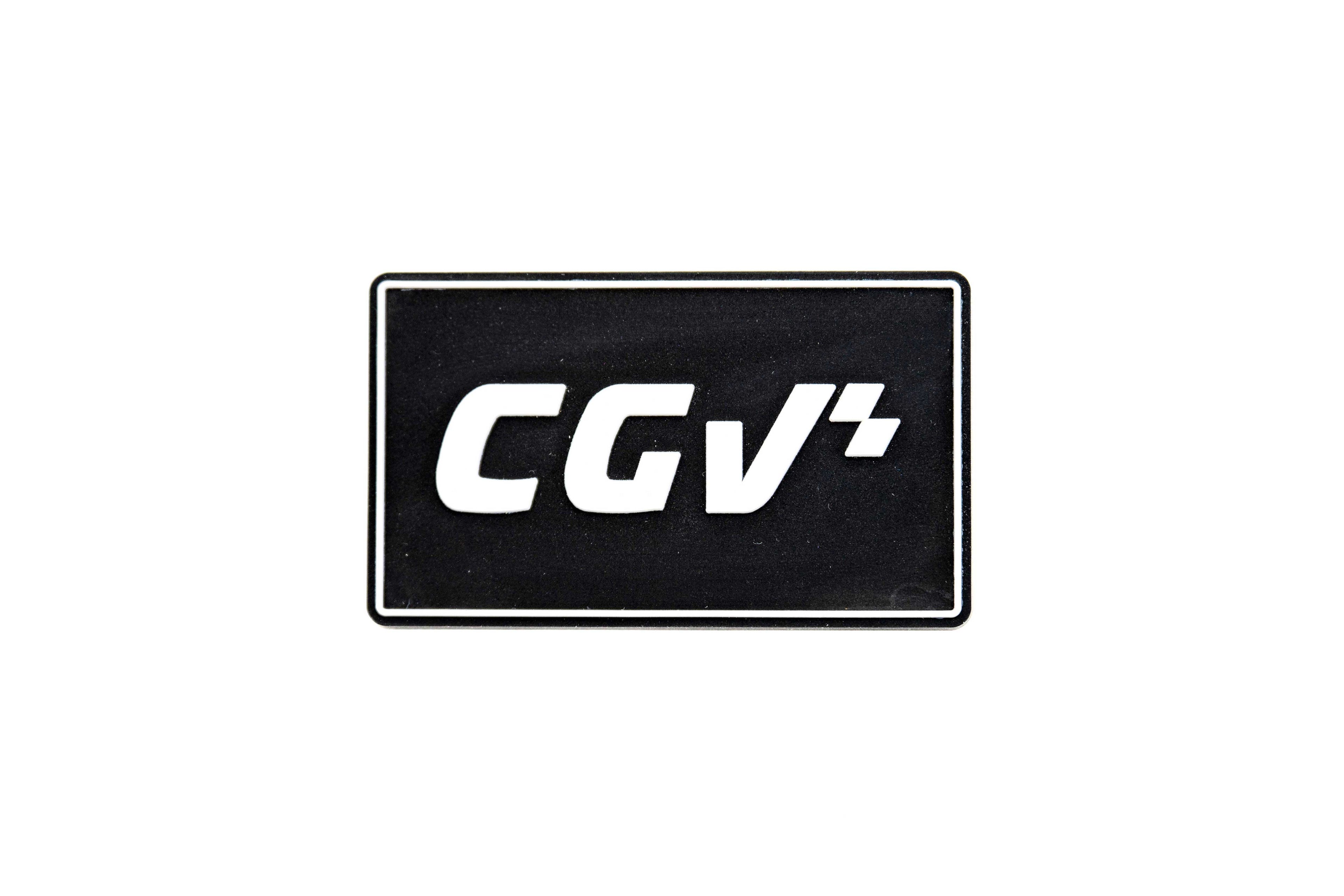 Aimant noir CGV apposé sur une surface grise, avec logo blanc centré.