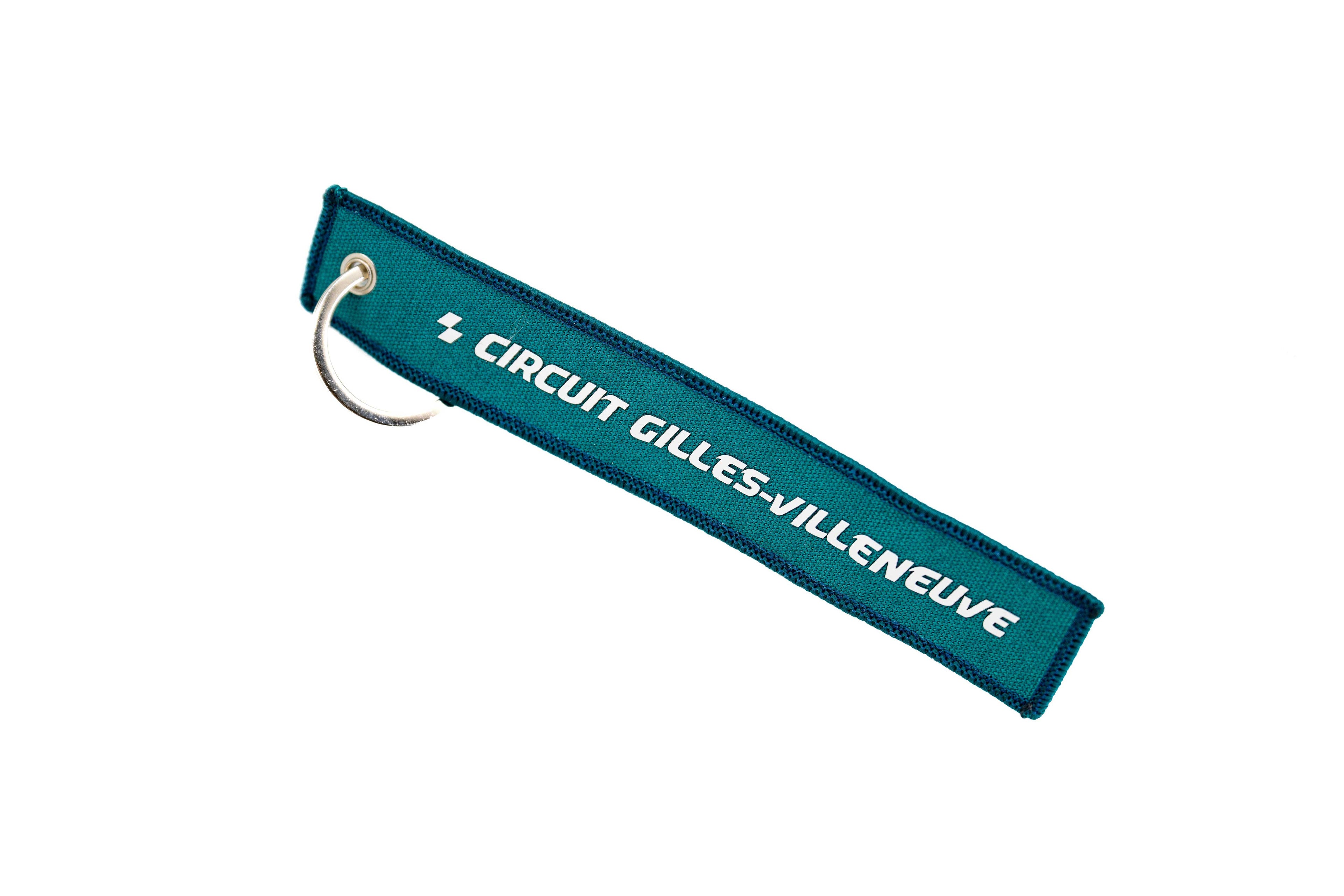 Porte-clés CGV turquoise à plat, avec anneau métallique visible.